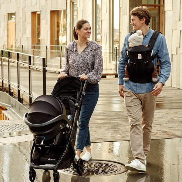 parents with baby going for a walk